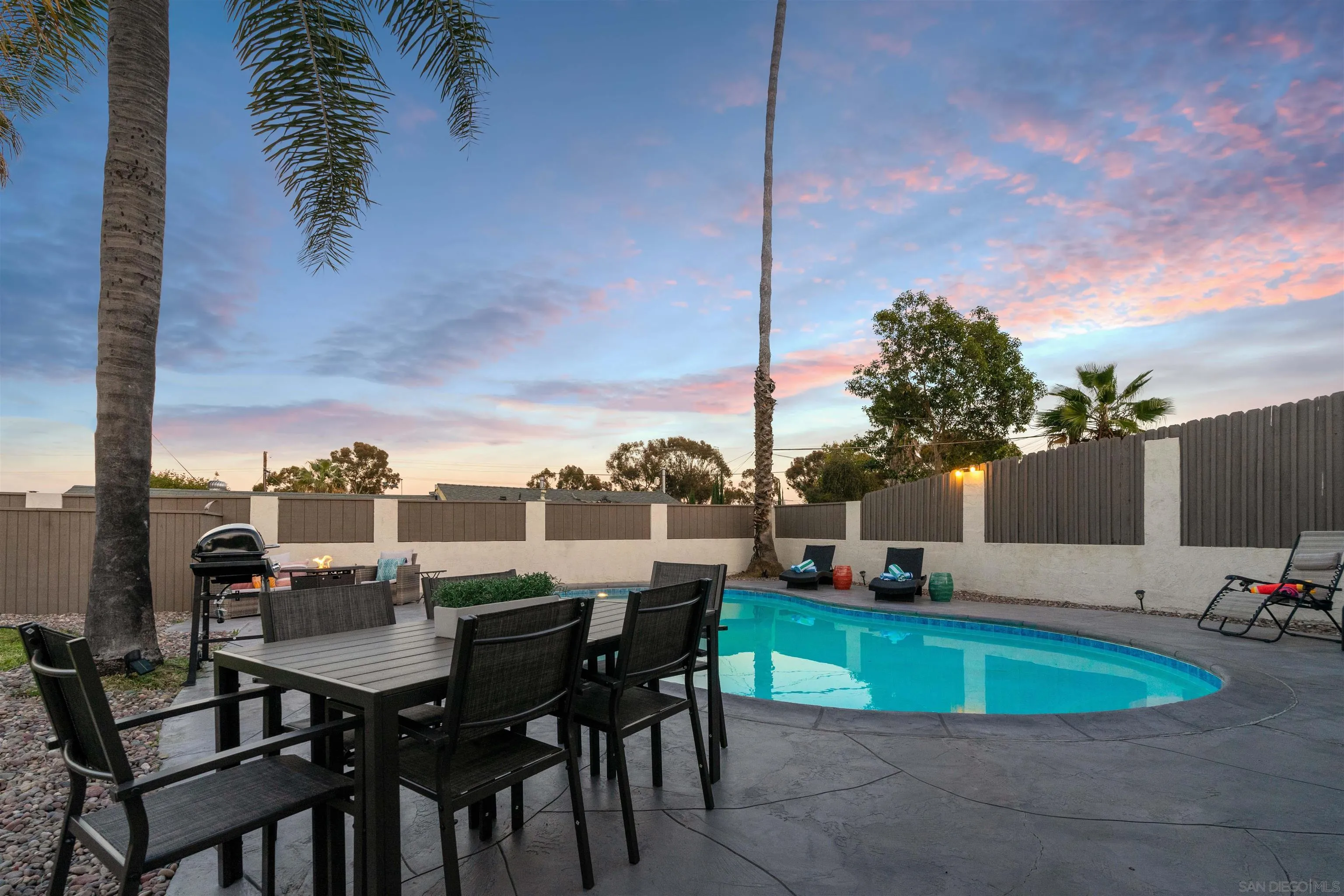 377 El Monte Road El Cajon, CA 92020 - Photo 14 of 16 a view of a swimming pool with a table and chairs