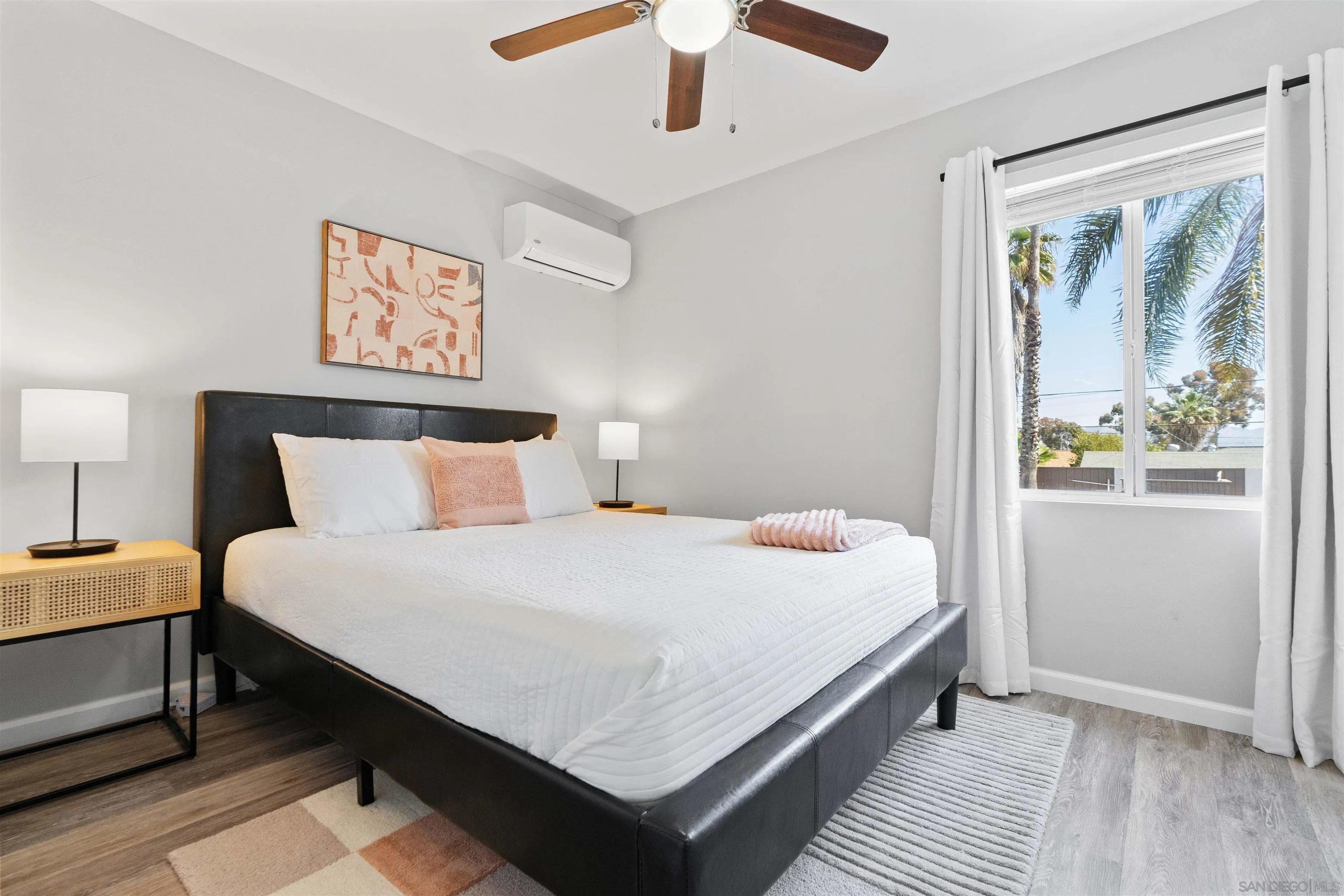 377 El Monte Road El Cajon, CA 92020 - Photo 15 of 16 a large bed sitting in a bedroom next to a lamp