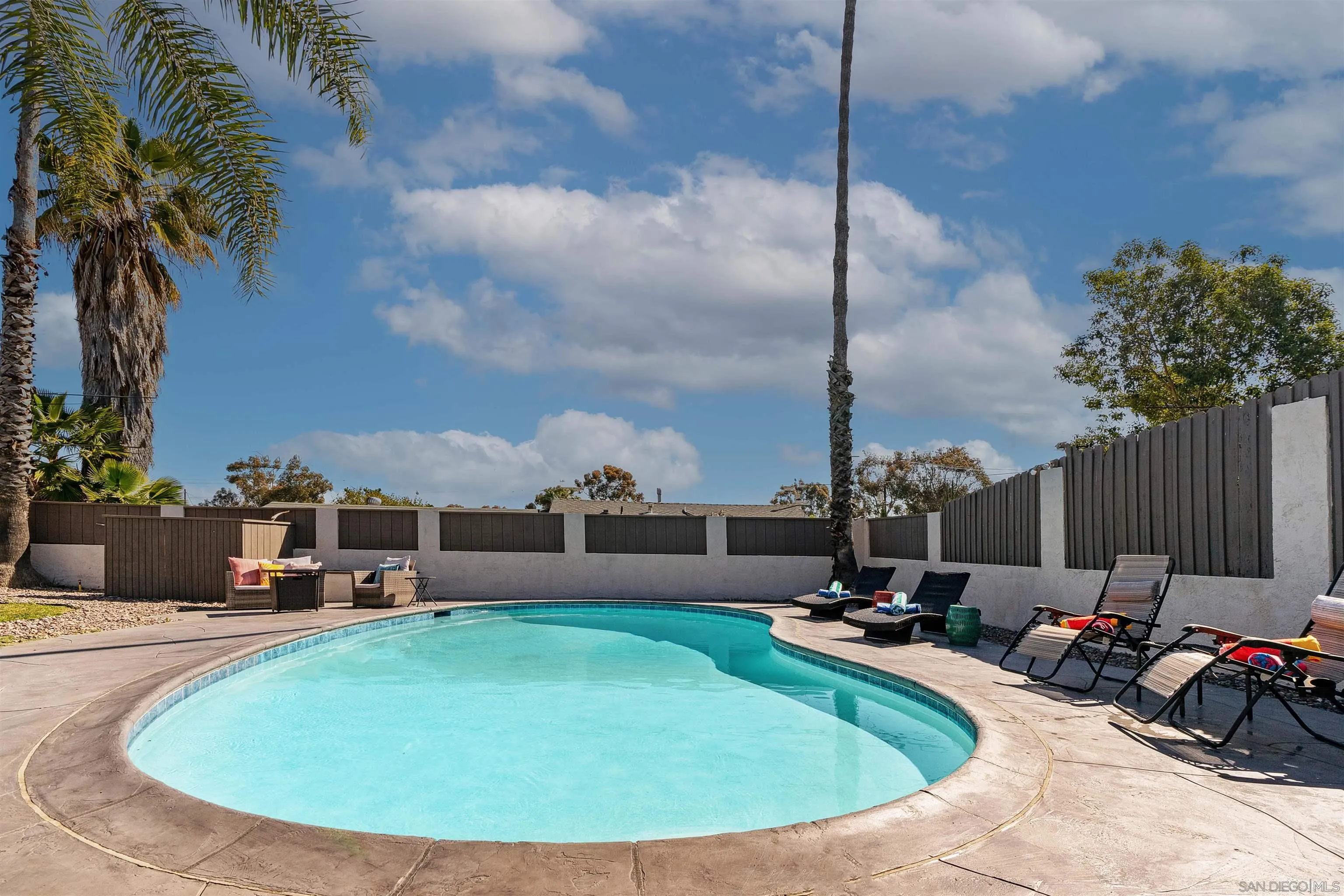 377 El Monte Road El Cajon, CA 92020 - Photo 16 of 16 a view of a swimming pool with a sitting space