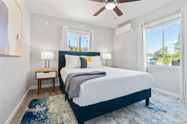 a bedroom with bed and window