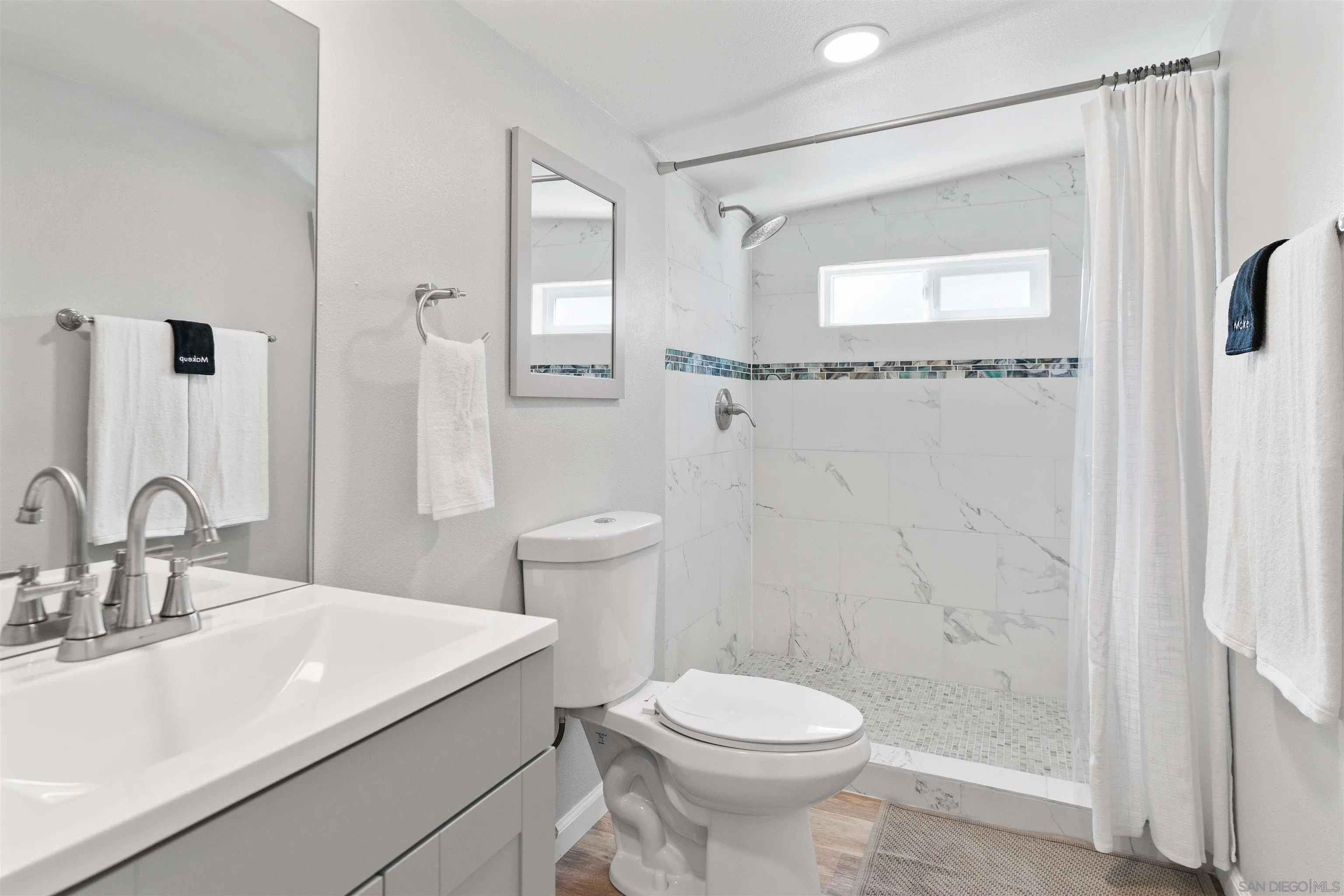 377 El Monte Road El Cajon, CA 92020 - Photo 9 of 16 a bathroom with a sink a toilet and shower