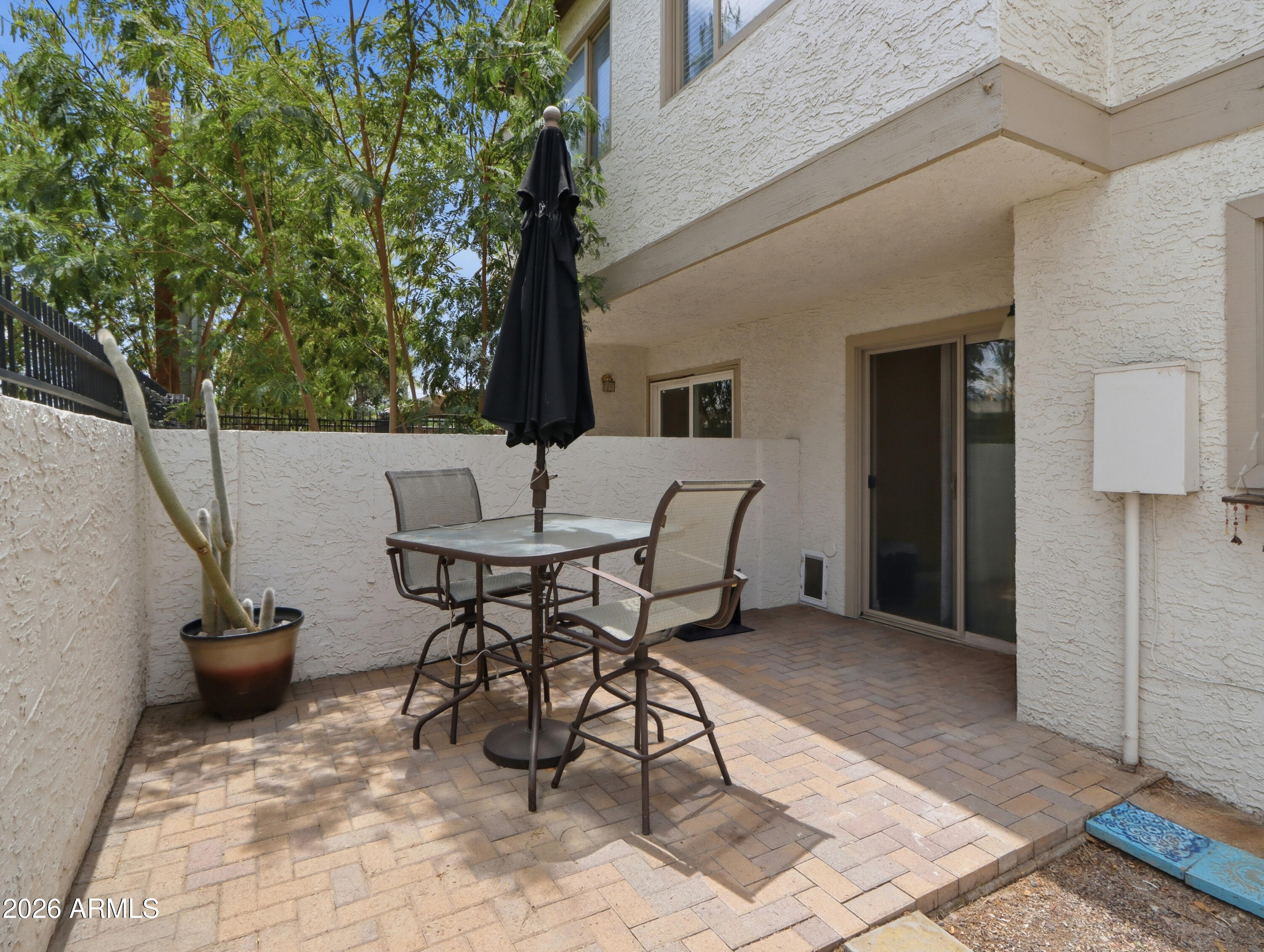 1402 East Osborn Road, Unit 2 Phoenix, AZ 85014 - Photo 21 of 29 a view of a patio with table and chairs and potted plants