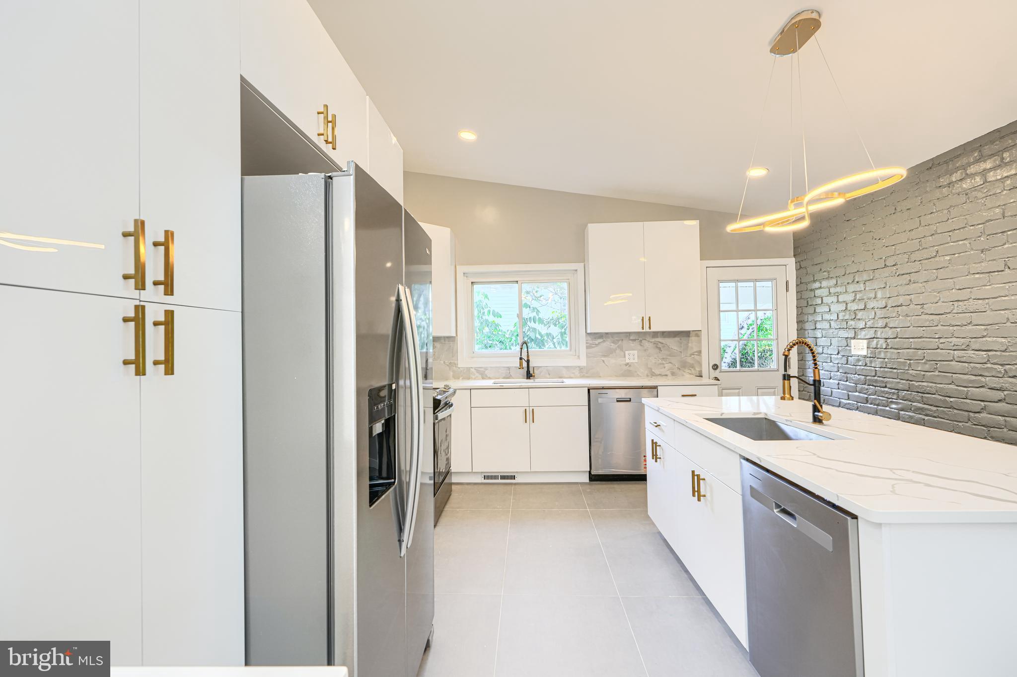 6200 Ivymount Road Baltimore, MD 21209 - Photo 20 of 71 a kitchen with a sink a refrigerator a window and cabinets