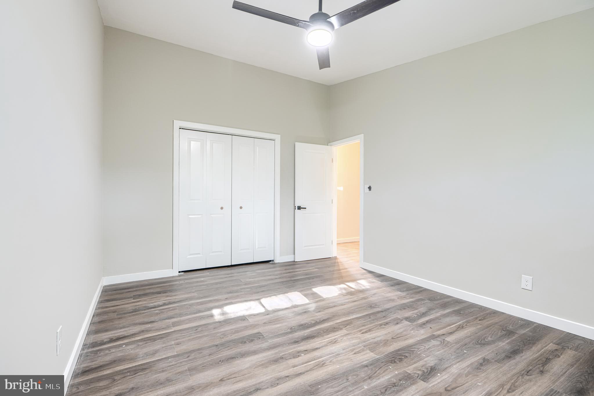 6200 Ivymount Road Baltimore, MD 21209 - Photo 27 of 71 an empty room with wooden floor and ceiling fan