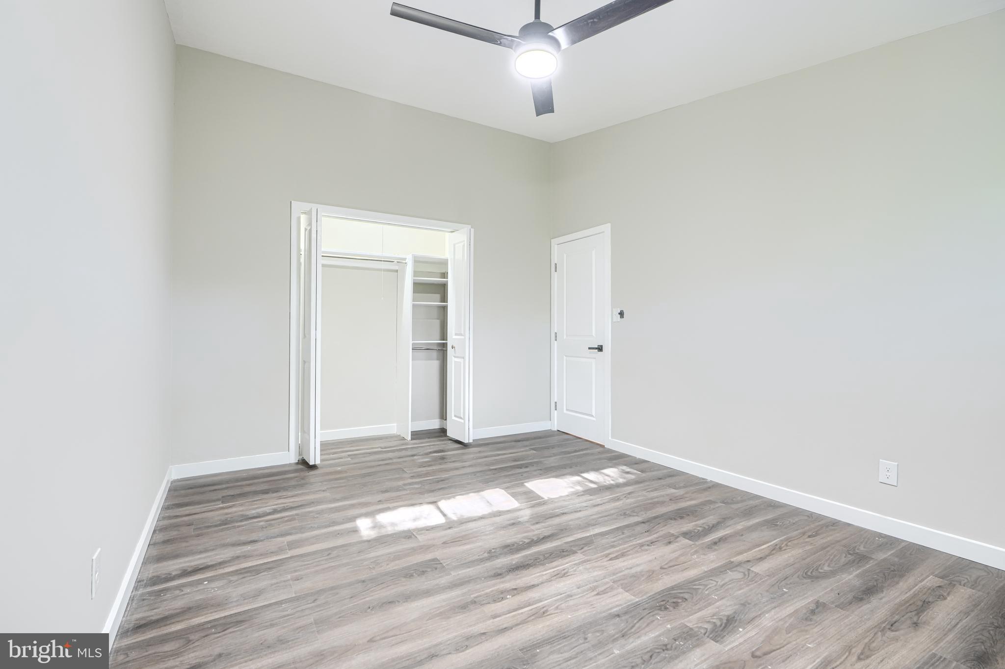 6200 Ivymount Road Baltimore, MD 21209 - Photo 28 of 71 an empty room with wooden floor and ceiling fan