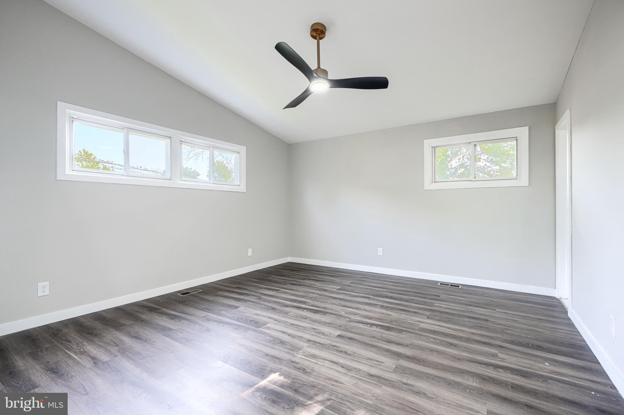 6200 Ivymount Road Baltimore, MD 21209 - Photo 38 of 71 a view of an empty room with wooden floor and a window