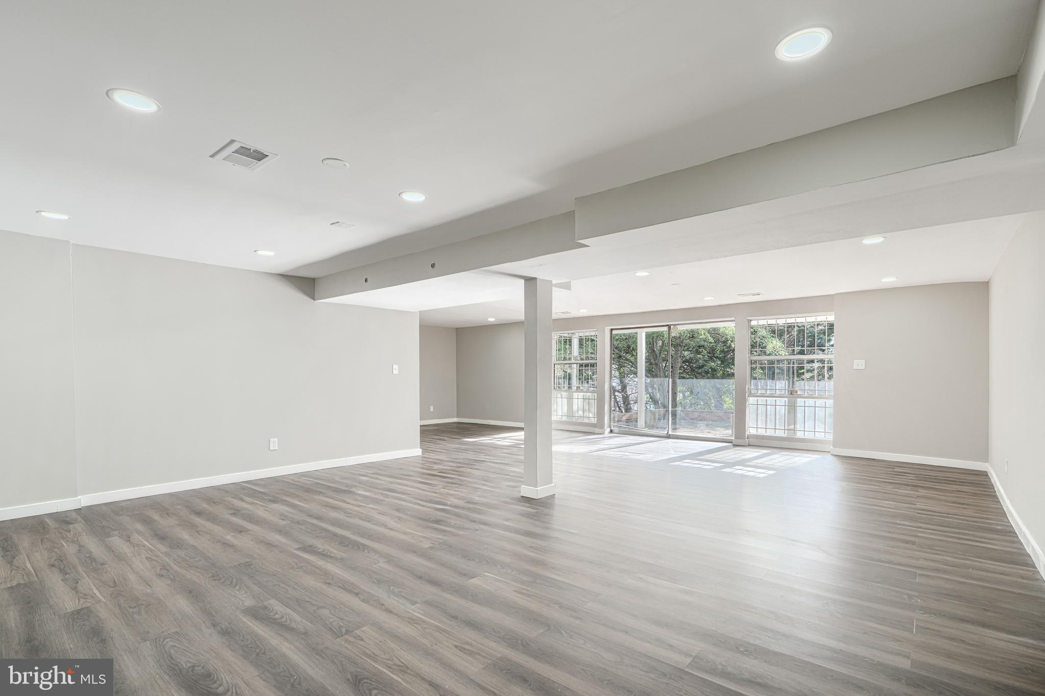 6200 Ivymount Road Baltimore, MD 21209 - Photo 49 of 71 a view of an empty room with wooden floor and a window