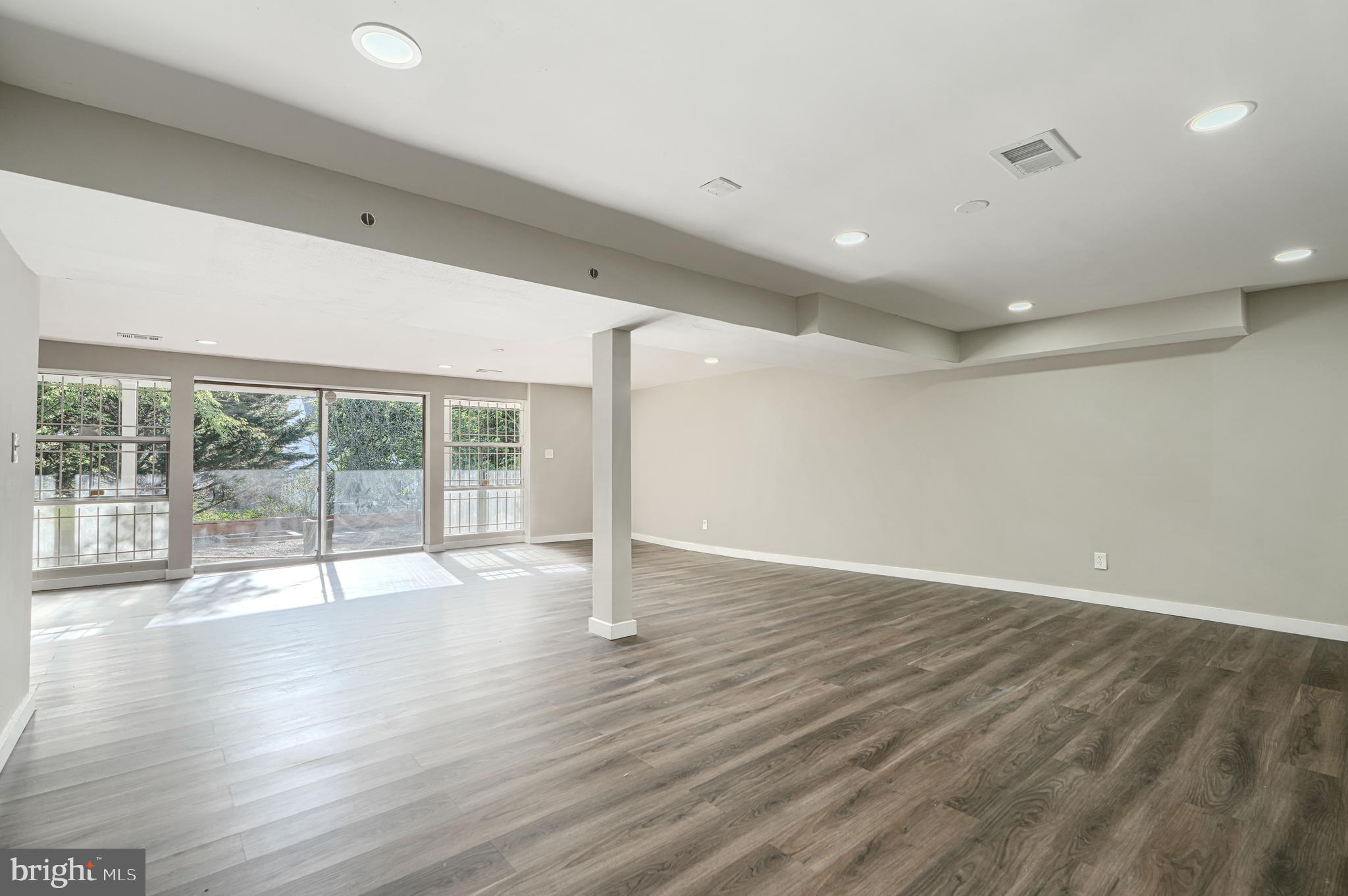 6200 Ivymount Road Baltimore, MD 21209 - Photo 50 of 71 a view of an empty room with wooden floor and a window