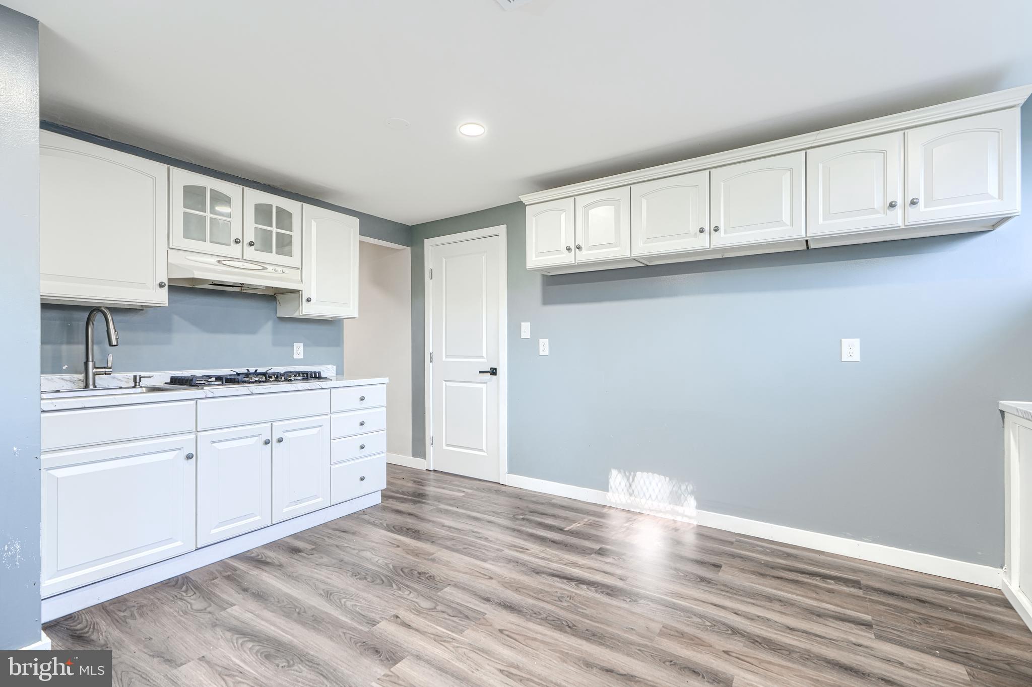 6200 Ivymount Road Baltimore, MD 21209 - Photo 53 of 71 a kitchen with granite countertop white cabinets and a sink