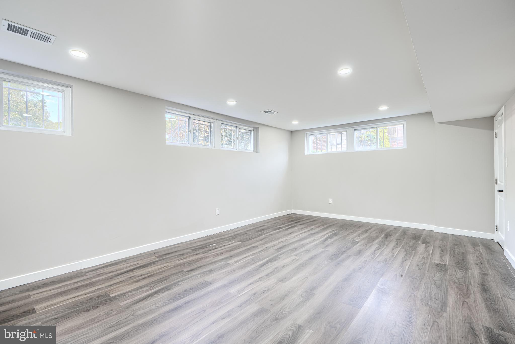 6200 Ivymount Road Baltimore, MD 21209 - Photo 56 of 71 a view of an empty room with wooden floor and a window