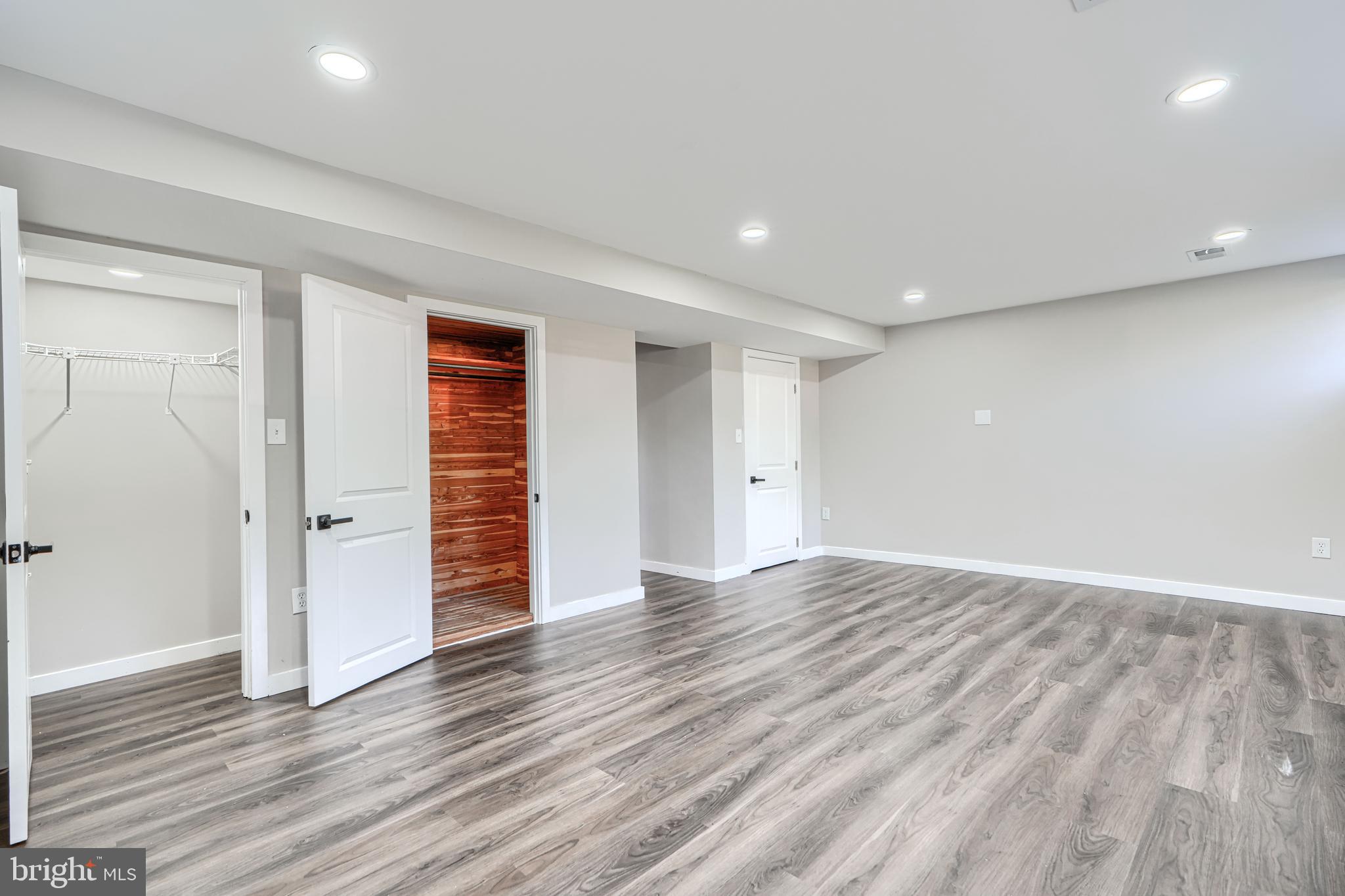 6200 Ivymount Road Baltimore, MD 21209 - Photo 57 of 71 a view of an empty room with wooden floor and closet