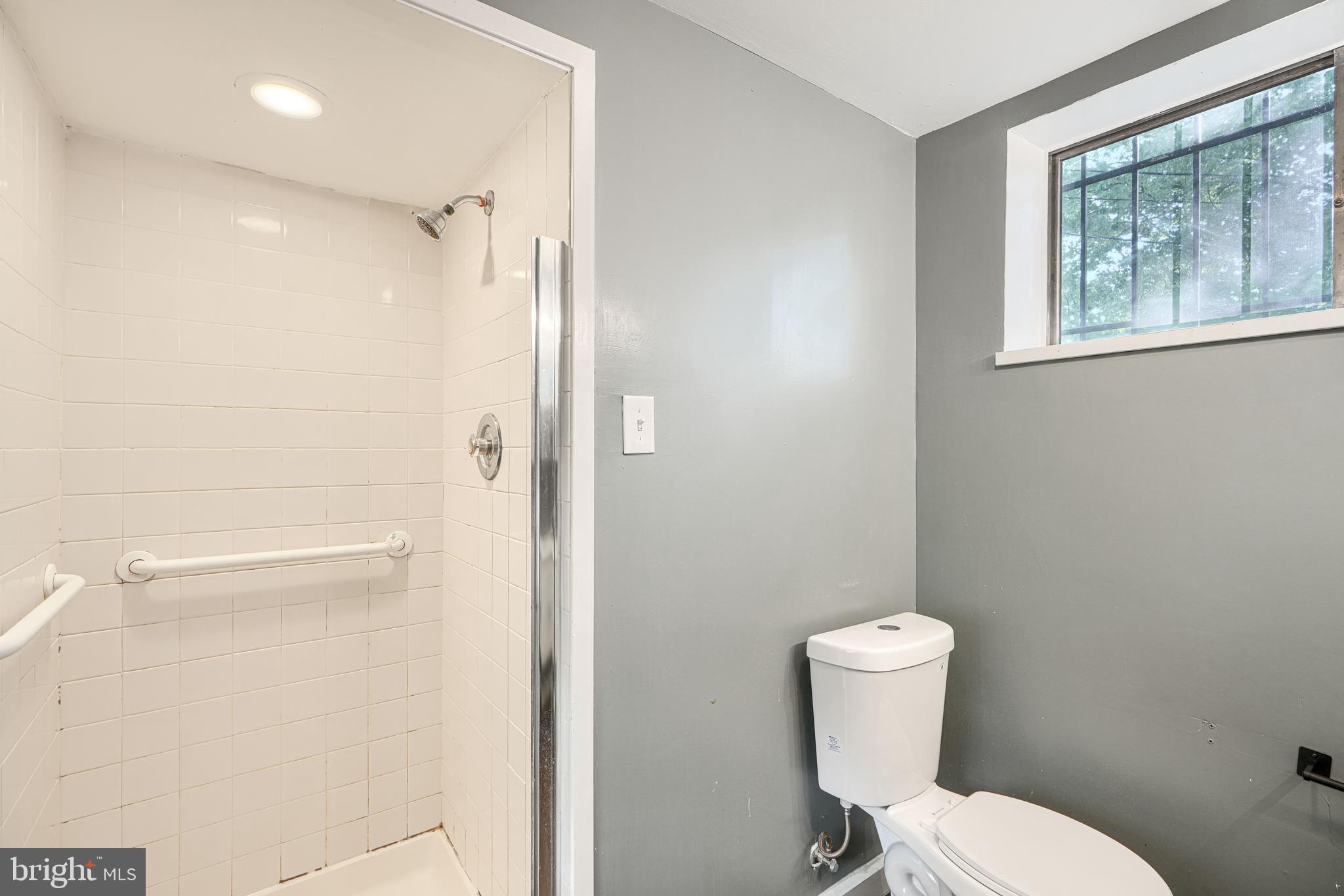 6200 Ivymount Road Baltimore, MD 21209 - Photo 59 of 71 a white toilet sitting next to a bathroom sink