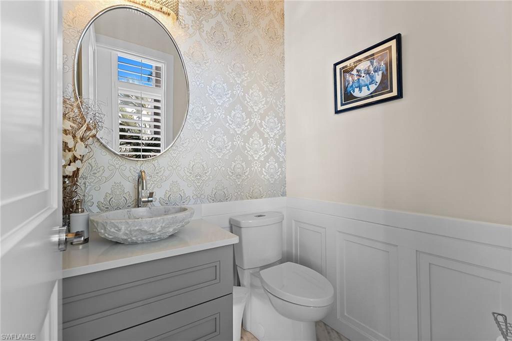 720 Orchid Drive Naples, FL 34102 - Photo 11 of 50 a bathroom with a toilet a sink and a window