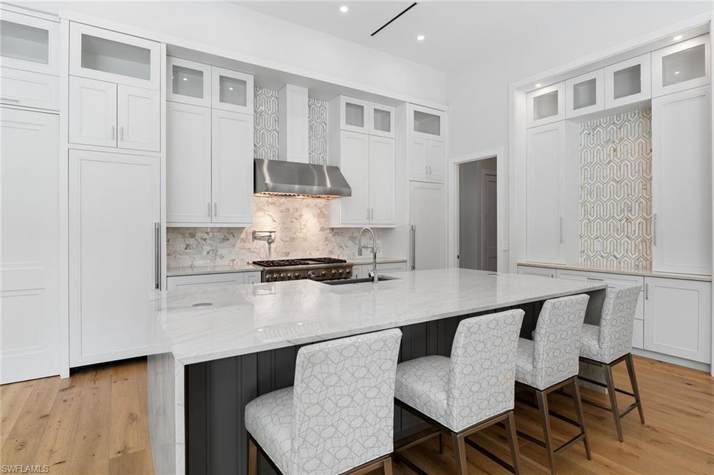 720 Orchid Drive Naples, FL 34102 - Photo 14 of 50 a kitchen with a table and chairs in it