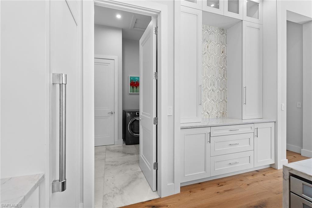 720 Orchid Drive Naples, FL 34102 - Photo 18 of 50 a view of a hallway with wooden floor