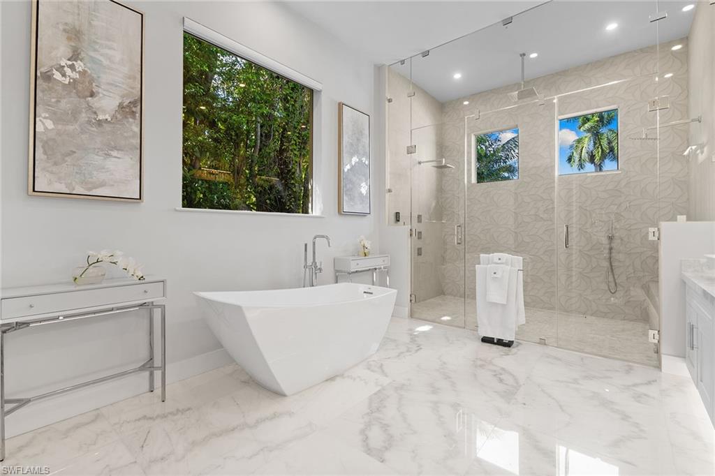 720 Orchid Drive Naples, FL 34102 - Photo 24 of 50 a spacious bathroom with a bathtub and a sink