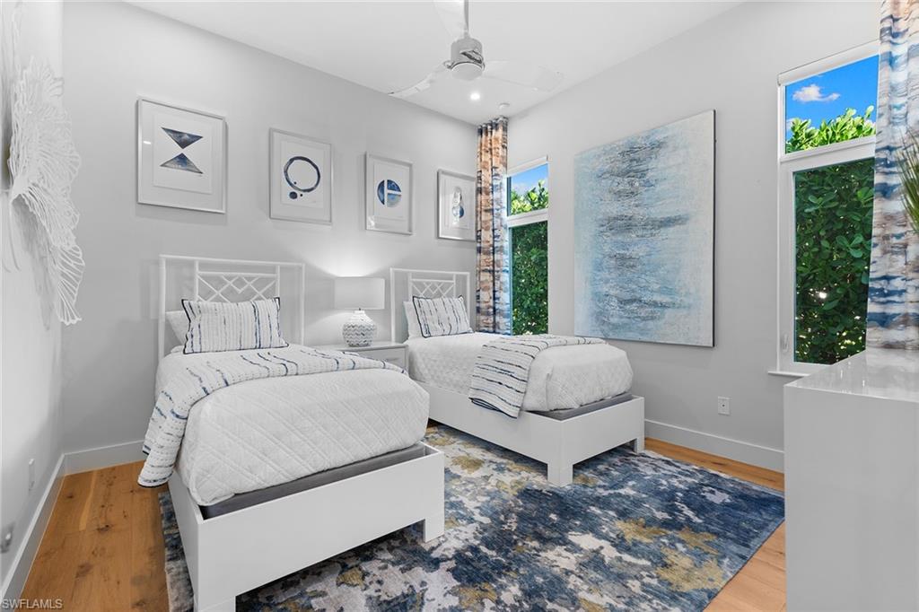 720 Orchid Drive Naples, FL 34102 - Photo 29 of 50 a bedroom with a large bed and a window