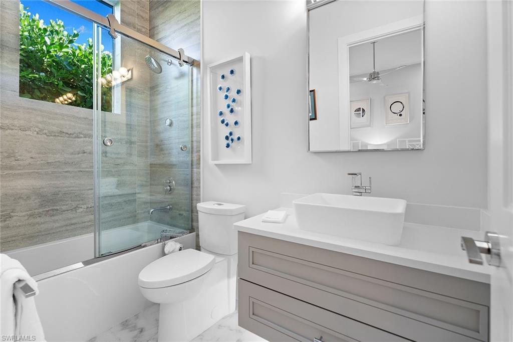 720 Orchid Drive Naples, FL 34102 - Photo 30 of 50 a bathroom with a sink a toilet and shower