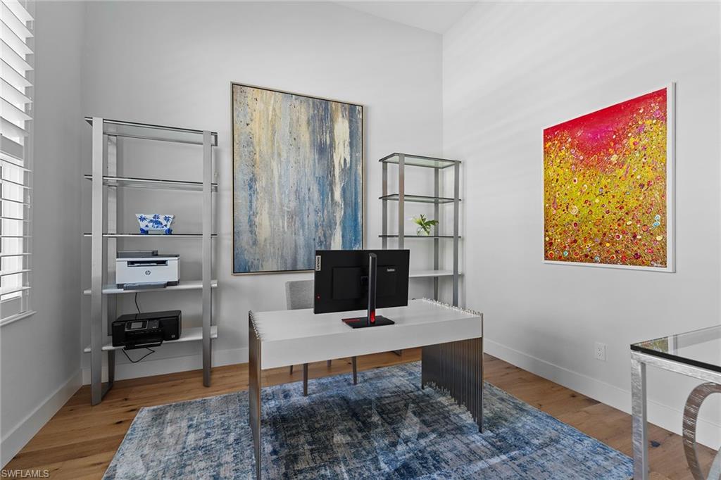 720 Orchid Drive Naples, FL 34102 - Photo 33 of 50 a living room with furniture a rug and a window