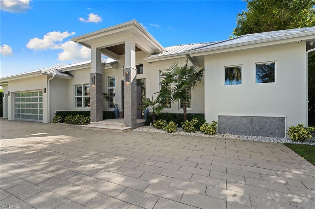 720 Orchid Drive Naples, FL 34102 - Photo 44 of 50 a front view of a house with garden