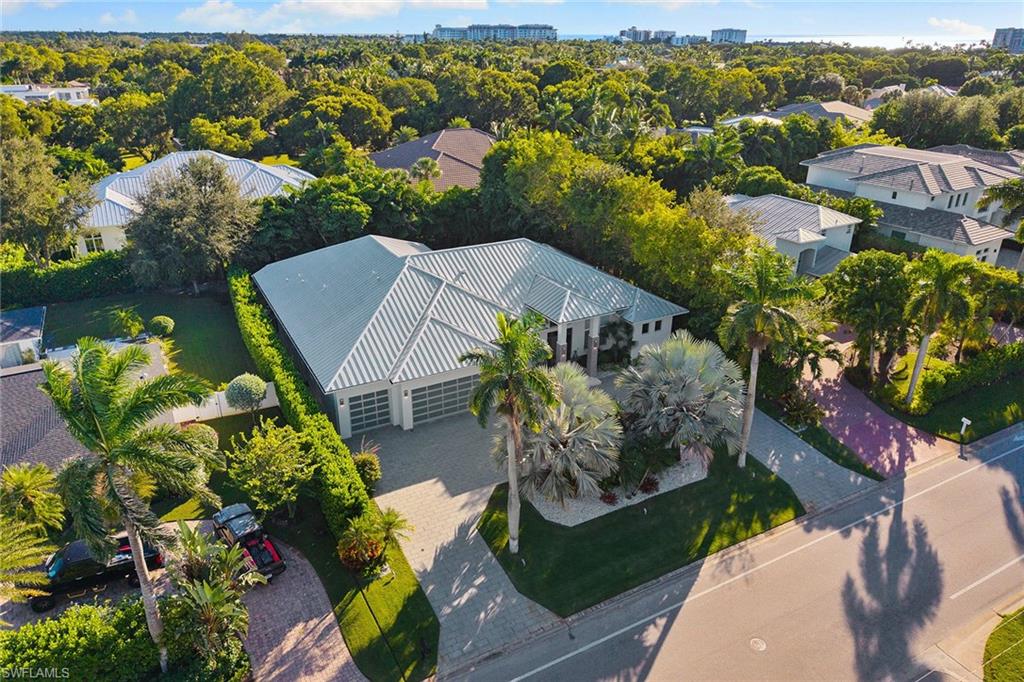720 Orchid Drive Naples, FL 34102 - Photo 48 of 50 an aerial view of a house with a yard and lake view