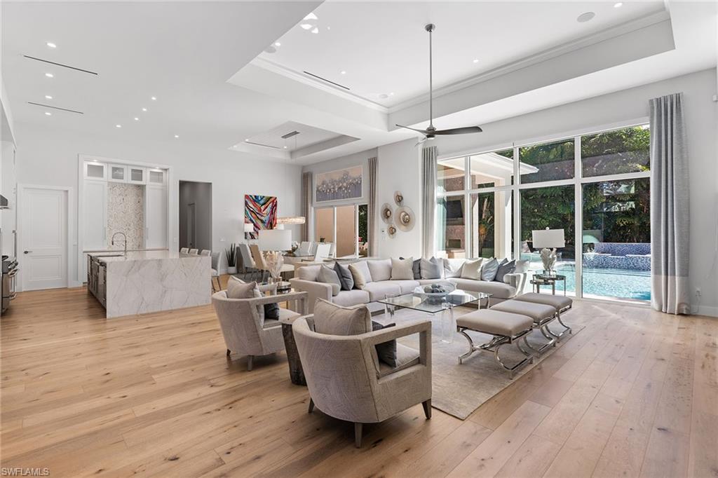 720 Orchid Drive Naples, FL 34102 - Photo 8 of 50 a living room with furniture large window and wooden floor