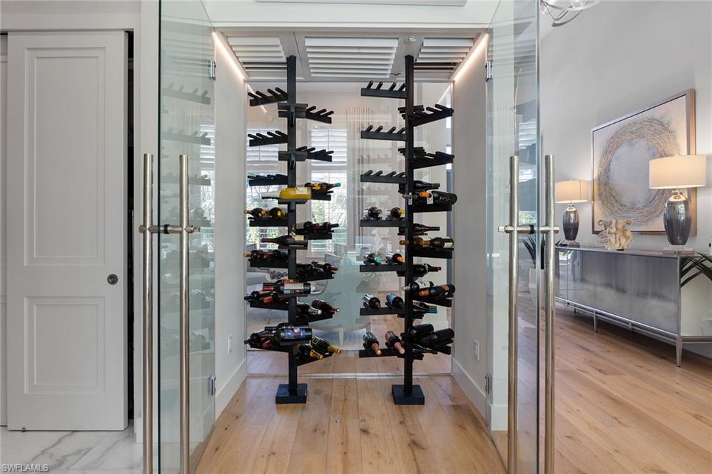 720 Orchid Drive Naples, FL 34102 - Photo 10 of 50 a view of bathroom with bathtub and wooden floor