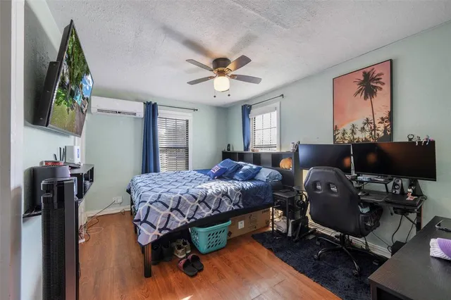 a bedroom with bed and a chandelier