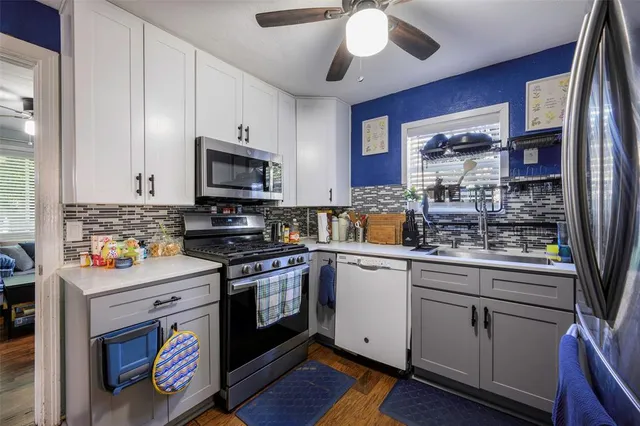 a kitchen with stainless steel appliances granite countertop a stove and a sink