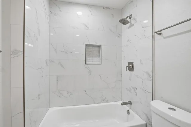 a bathroom with a bathtub and a shower