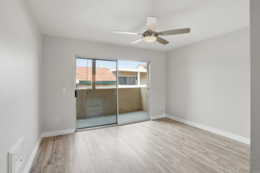 3435 Capalina Road, Unit 10 San Marcos, CA 92069 - Photo 15 of 34 an empty room with wooden floor fan and windows