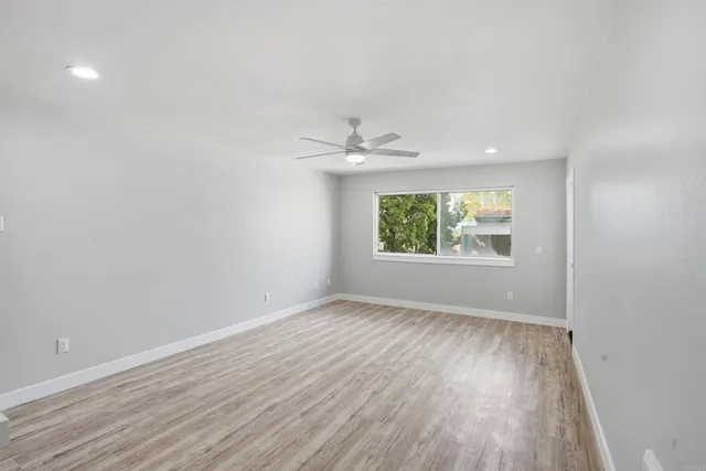 wooden floor in an empty room with a window