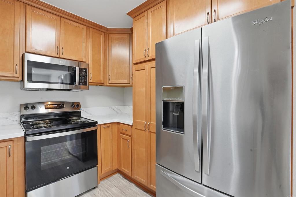 3435 Capalina Road, Unit 10 San Marcos, CA 92069 - Photo 3 of 34 a kitchen with stainless steel appliances granite countertop a refrigerator stove and microwave