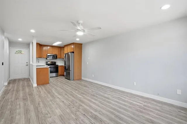 a kitchen with stainless steel appliances a refrigerator and a microwave