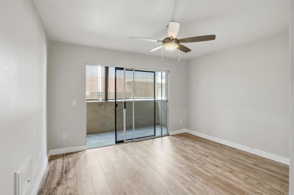 3435 Capalina Road, Unit 10 San Marcos, CA 92069 - Photo 10 of 34 an empty room with wooden floor fan and windows
