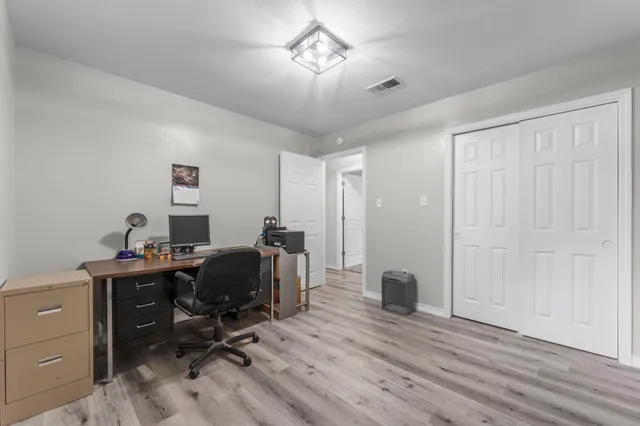 a view of a workspace with furniture and a window