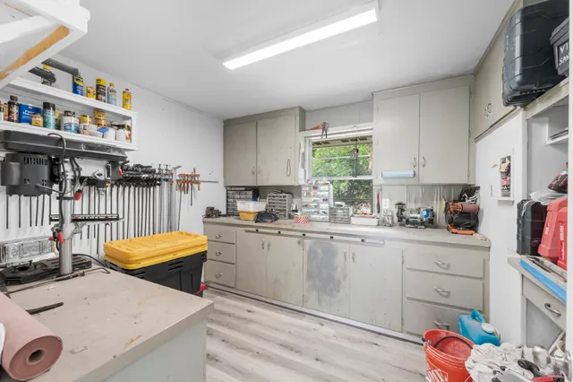 a kitchen with stainless steel appliances a stove a sink cabinets and a window