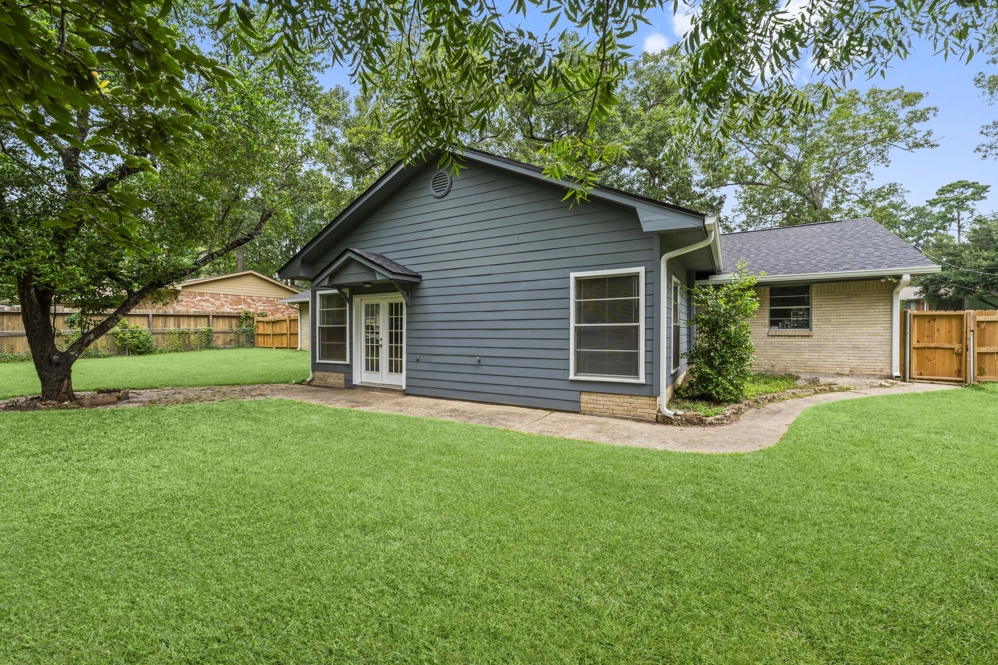 209 Summit Drive Conroe, TX 77303 - Photo 21 of 22 The back of the home highlights easy access to the large versatile game room; perfect as a media room, home office, play area, or even an expansive bedroom.