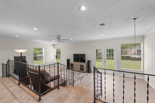 a living room with furniture tv and a window