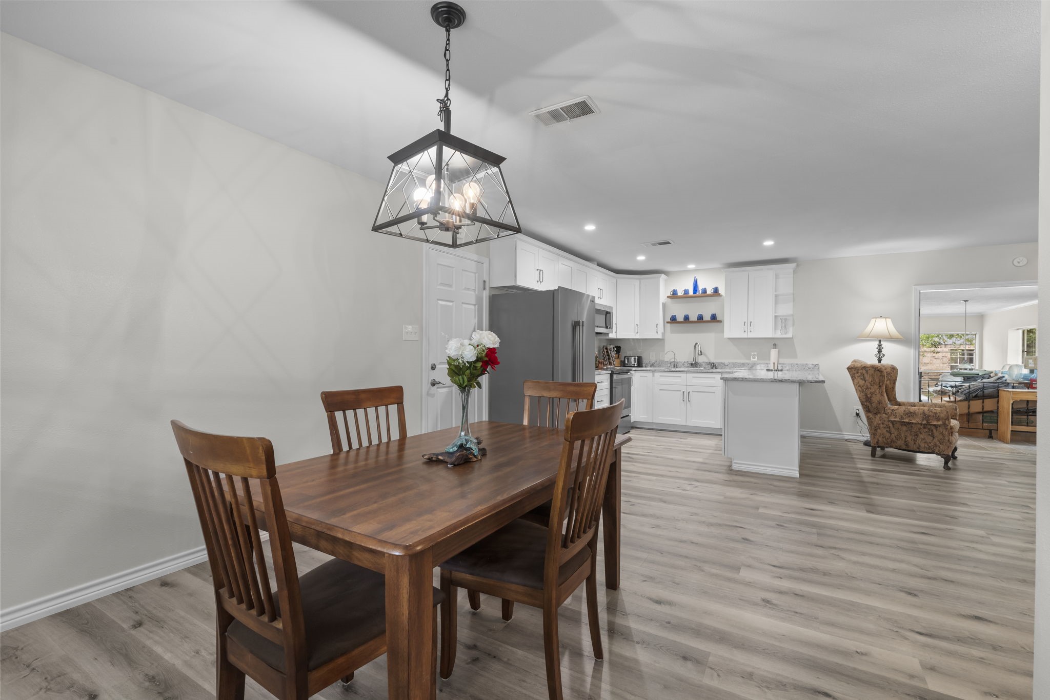 209 Summit Drive Conroe, TX 77303 - Photo 10 of 22 The open-concept dining area, located just off the kitchen, offers a bright and inviting space perfect for family meals and entertaining.