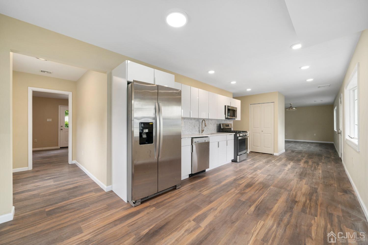68 Winthrop Road Edison, NJ 08817 - Photo 3 of 19 a open kitchen with white cabinets and stainless steel appliances