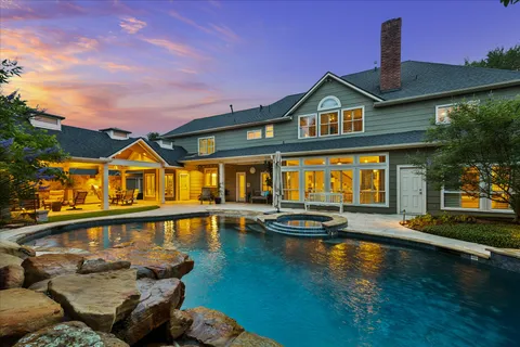 a view of a house with swimming pool and sitting area
