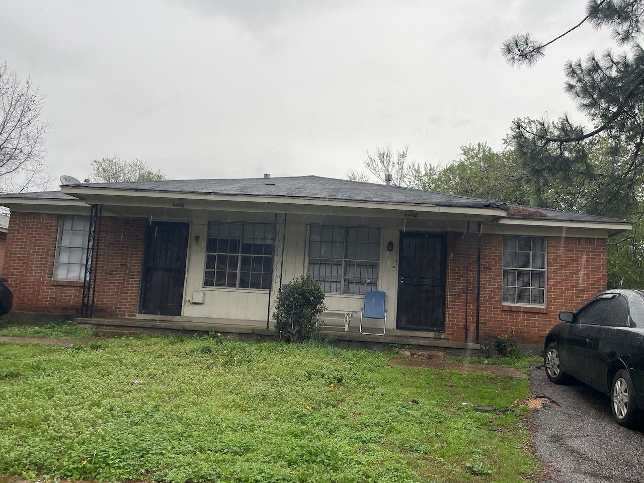 Single story home with a front lawn and brick siding