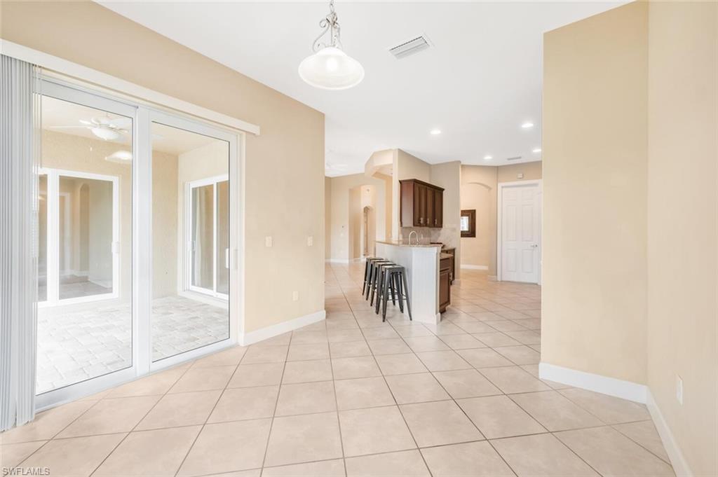 7975 Princeton Drive Naples, FL 34104 - Photo 14 of 28 a view of a livingroom with furniture and a ceiling fan