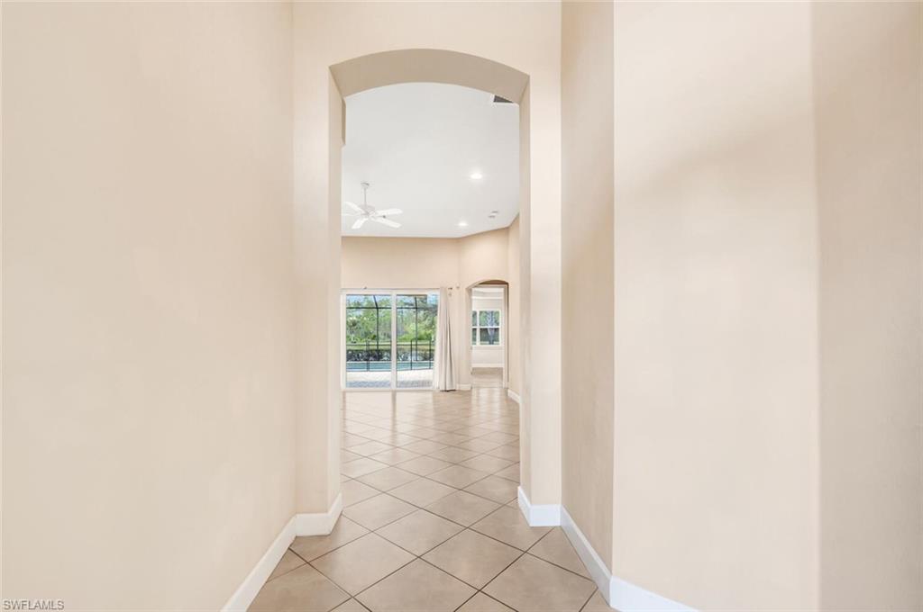 7975 Princeton Drive Naples, FL 34104 - Photo 7 of 28 a view of a livingroom with wooden floor and a potted plant