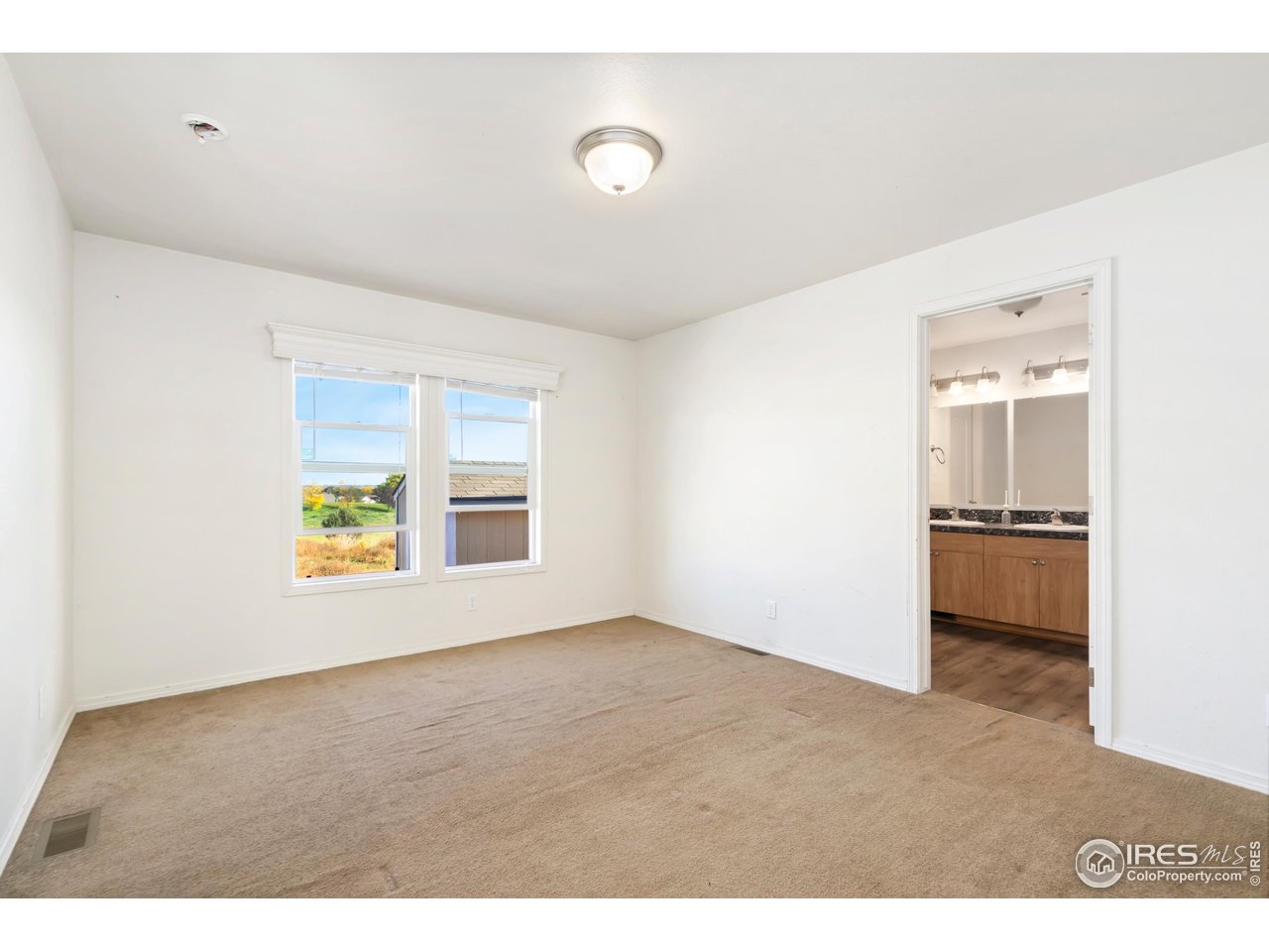 4324 Buffalo Trail Evans, CO 80620 - Photo 12 of 16 a view of an empty room with a window