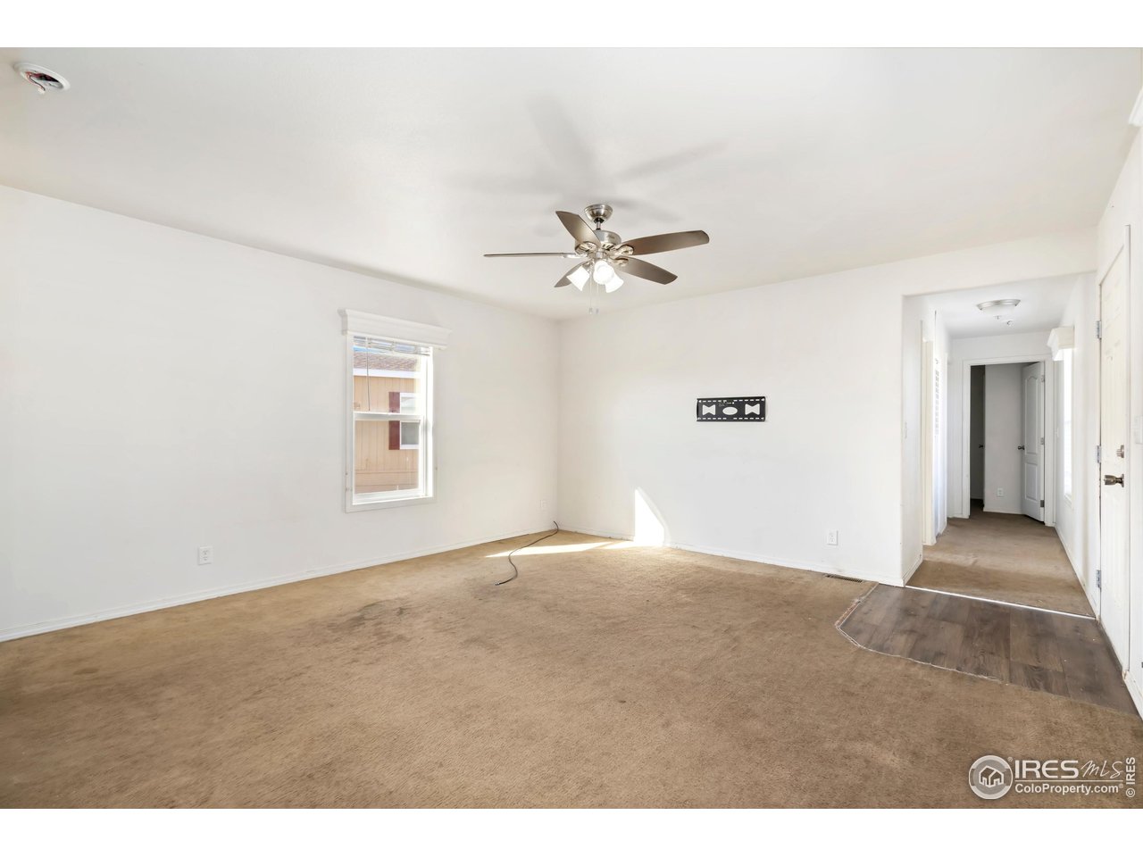 4324 Buffalo Trail Evans, CO 80620 - Photo 7 of 16 a view of an empty room with a ceiling fan