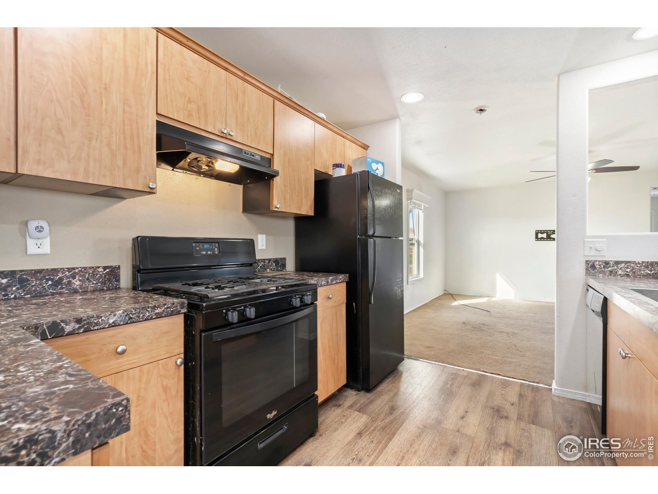 4324 Buffalo Trail Evans, CO 80620 - Photo 9 of 16 a kitchen with stainless steel appliances granite countertop a stove a refrigerator and a cabinets