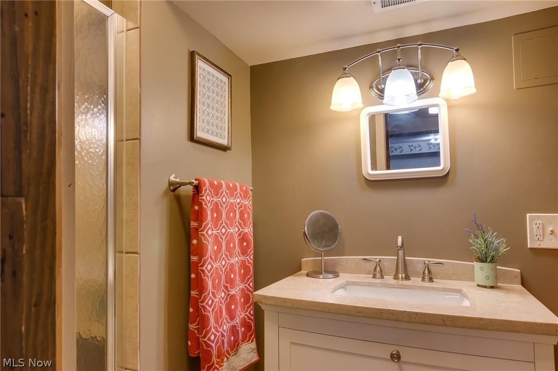 9790 Wilson Mills Road Chardon, OH 44024 - Photo 17 of 33 Fully updated basement bathroom in neutrals with new non skid shower stall - new vanity and lights - great ceramic tile flooring