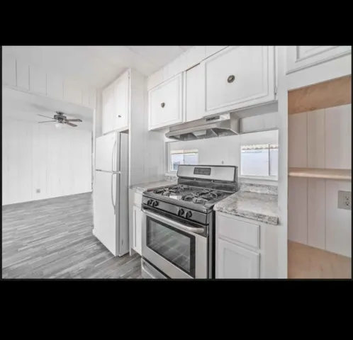 a kitchen with a stove and a refrigerator